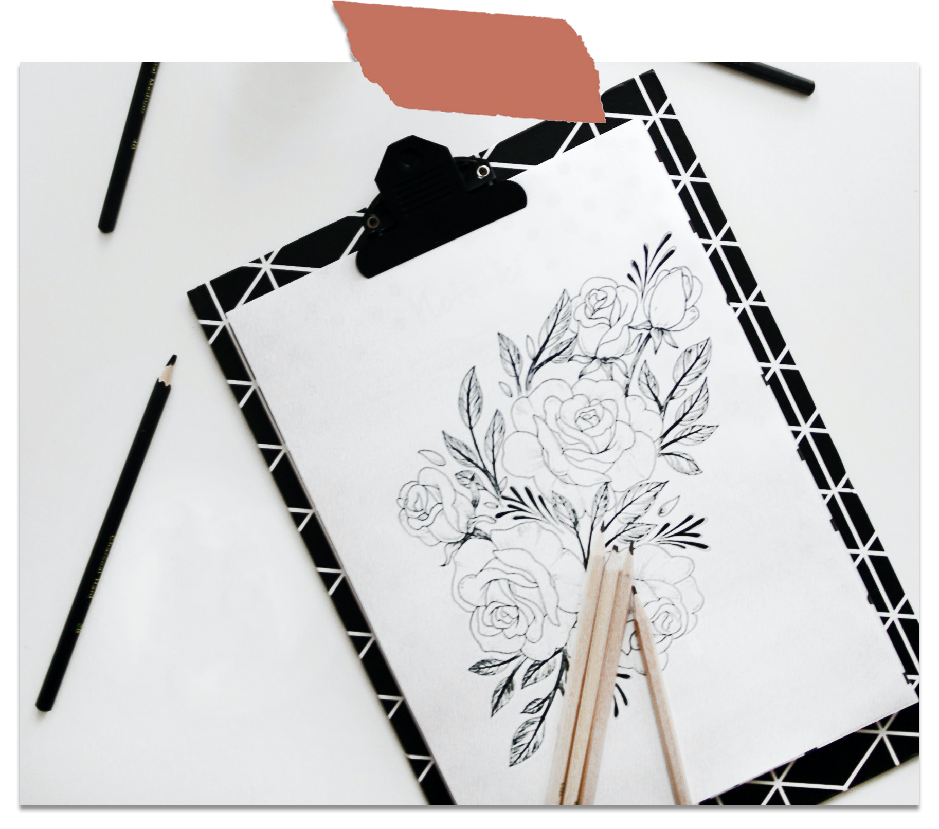 pencils on top of a drawing of flowers